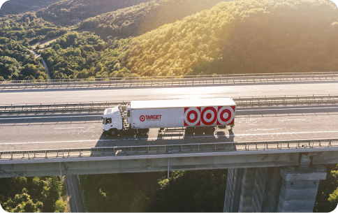 semi-trailer with Target branding driving over a bridge in the sunset