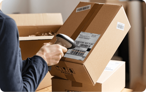 hand scanning a label on a cardboard box