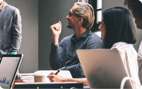 people sitting in an office talking in a meeting