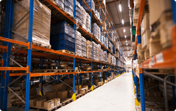 a large warehouse with shelves up to the ceiling holding pallets and boxes